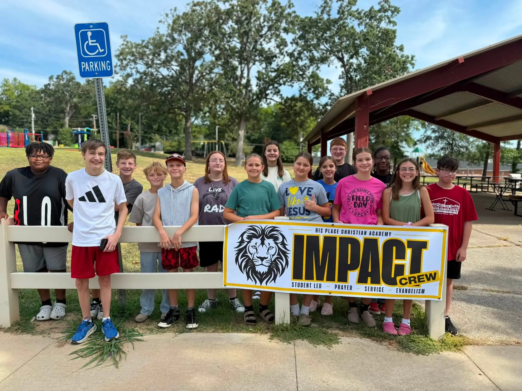 HPCA students outdoors with the IMPACT crew banner