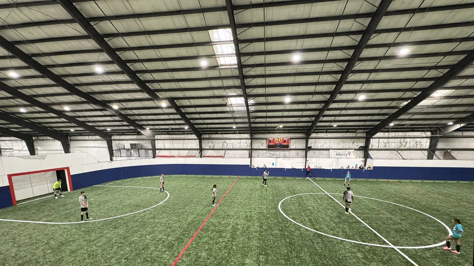 HPCA students playing indoor soccer on a turf field